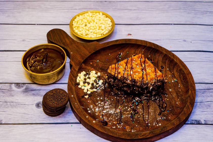 Belgian waffle served on a wooden board at a Waffcha outlet
